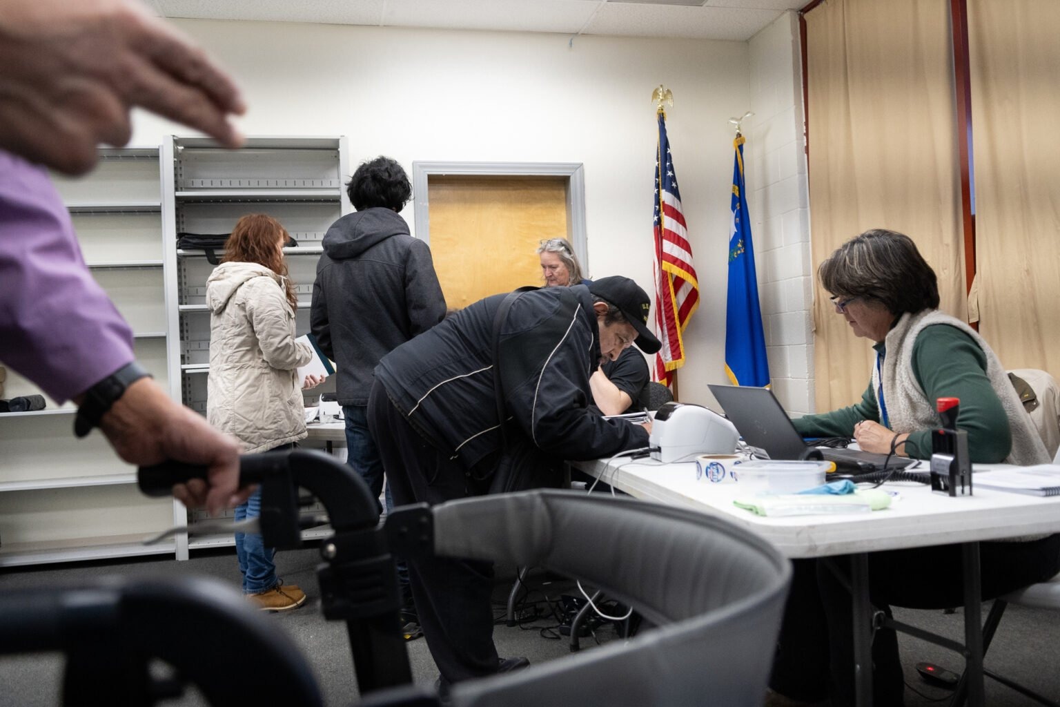 Voters check in to their polling place